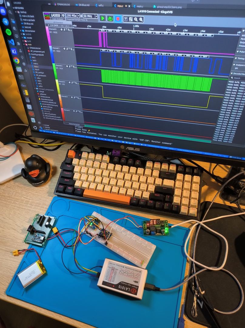 SPI debug session: KingstVIS logic analyzer software on monitor showing decoded MOSI/MISO/SCLK channels, LA1010 logic analyzer connected to breadboard with IMU module