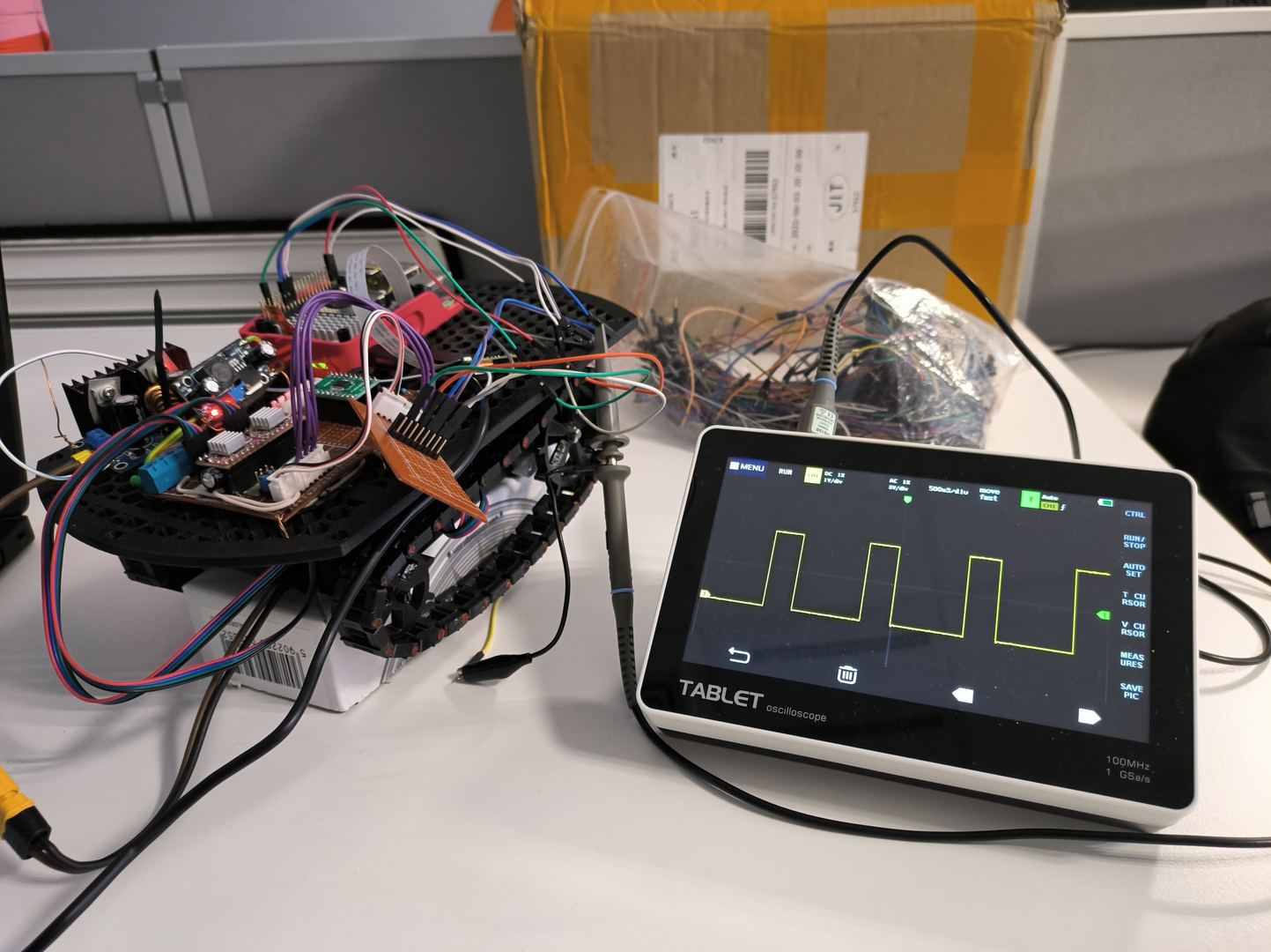 Oscilloscope probe connected to robot electronics during hardware debugging at GlobalLogic Poland internship