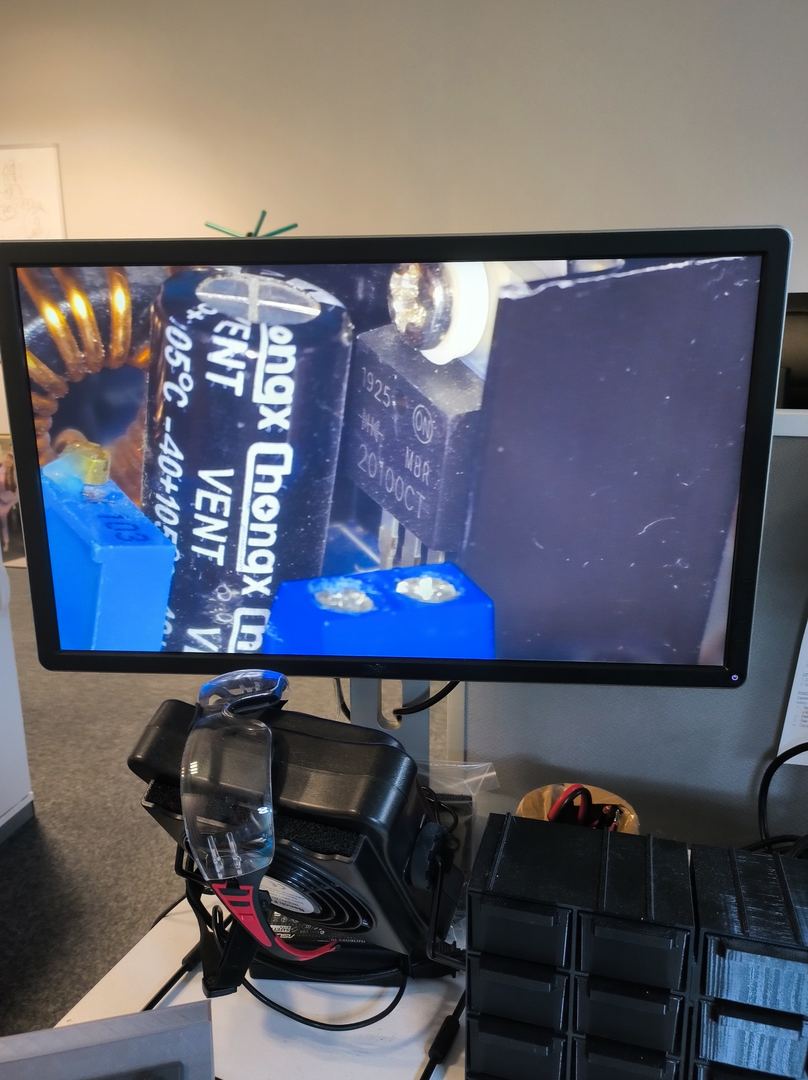 PCB inspection under microscope during hardware development at GlobalLogic Poland